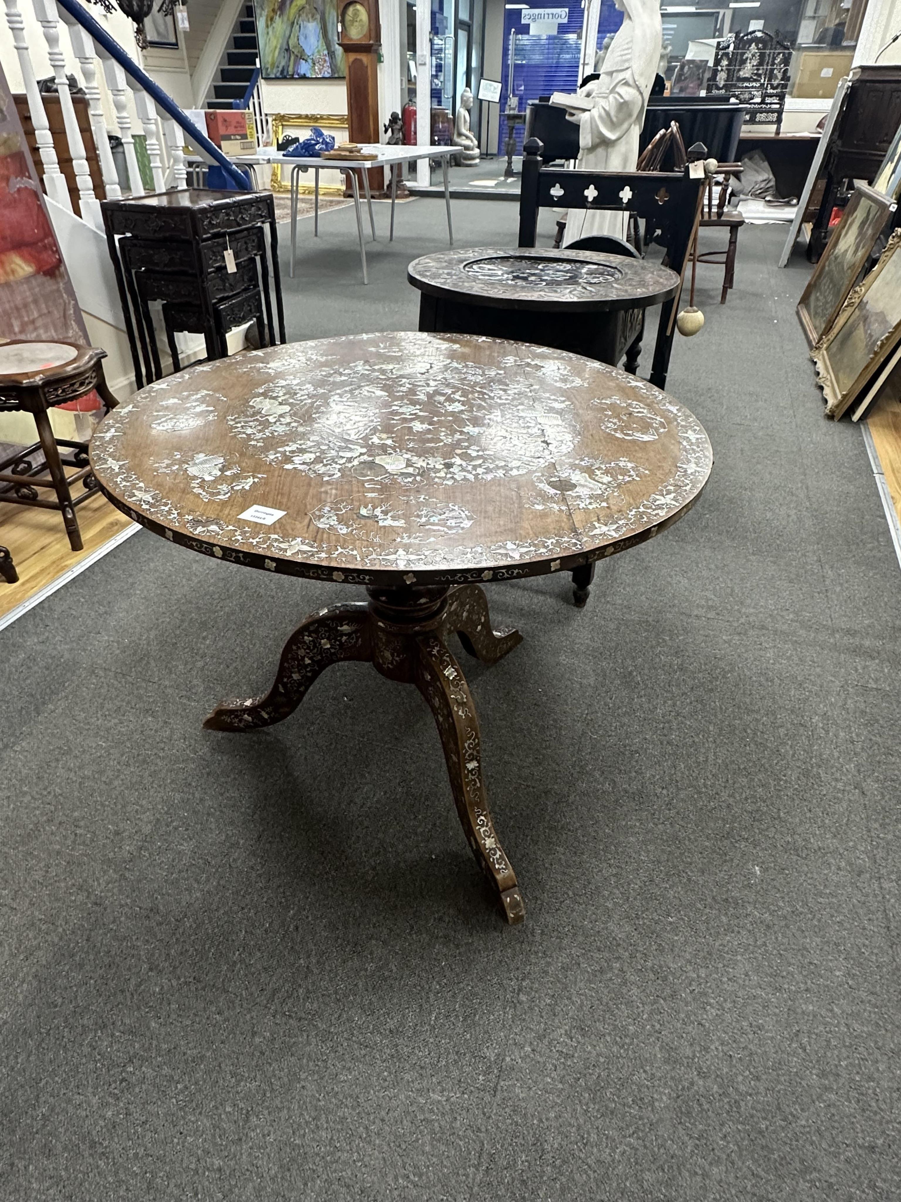 A circular Chinese export hardwood and mother of pearl inlaid centre table, diameter 85cm, height 64cm. Condition - cracked and some losses to the top and elsewhere
